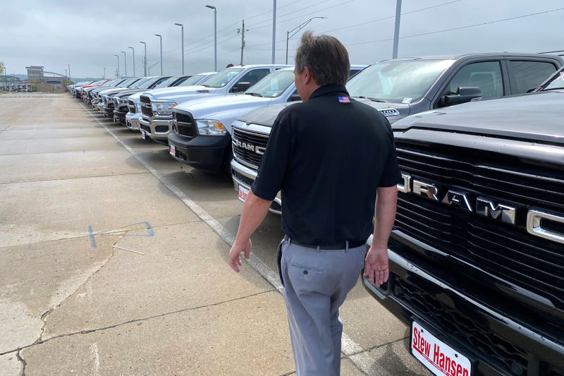 &copy; Reuters. Jerry Bill, general manager of Stew Hansen Chrysler Dodge Jeep Ram, walks past a line of Ram trucks in Urbandale
