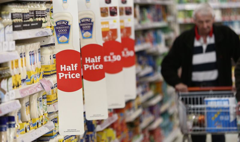 &copy; Reuters. A shopper pushes a trolley in a supermarket in London