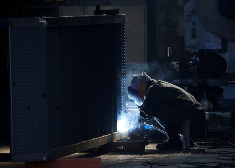 &copy; Reuters. A man works at a factory at the Keihin industrial zone in Kawasaki