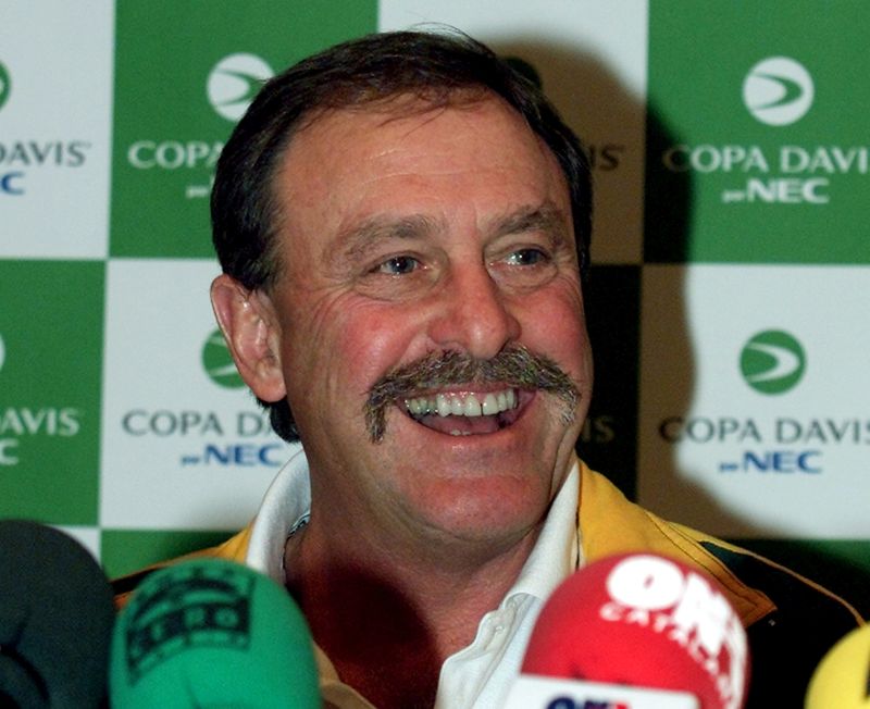 © Reuters. FILE PHOTO: AUSTRALIAN DAVIS CUP CAPTAIN JOHN NEWCOMBE SMILES AT PRESS CONFERENCE IN BARCELONA.