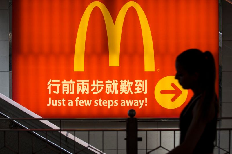 &copy; Reuters. A woman walks past a logo of McDonald&apos;s in Hong Kong