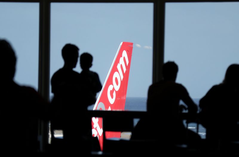 &copy; Reuters. People look out at a Jet2.com aircraft from the departures area of Lanzarote Airport, in Lanzarote