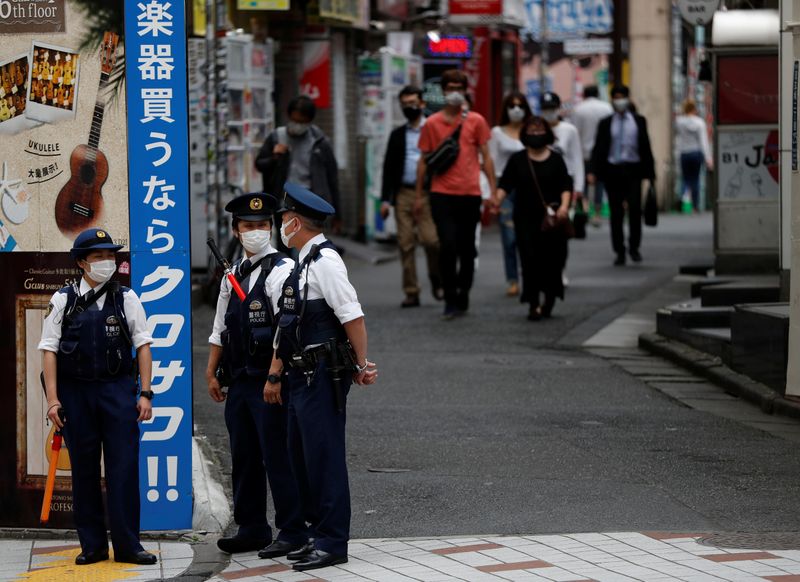 &copy; Reuters. Agentes de policía con mascarillas en el distrito de compras y diversión de Shibuya en Tokio, Japón, el 25 de mayo de 2020