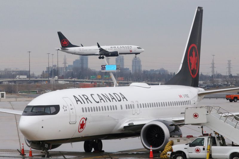 &copy; Reuters. FILE PHOTO: An Air Canada Boeing 737 MAX 8 from San Francisco approaches for landing at Toronto Pearson International Airport over a parked Air Canada Boeing 737 MAX 8 aircraft in Toronto
