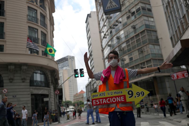 &copy; Reuters. FILE PHOTO: A man wearing protective face mask, as a precautionary measure against coronavirus disease (COVID-19) calls for drivers to park in downtown Sao Paulo