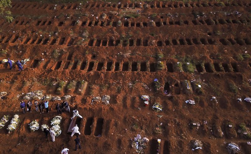 &copy; Reuters. Sepultadores com trajes de proteção enterram vítima de Covid-19 no cemitério de Vila Formosa, em São Paulo