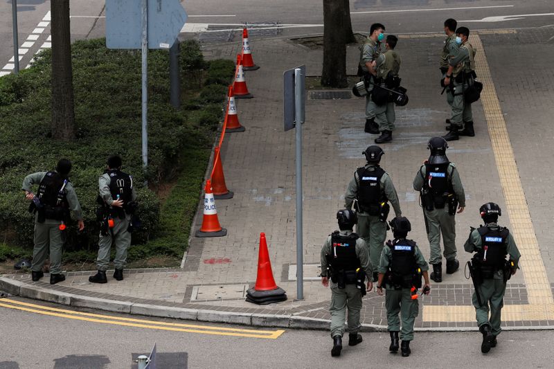 © Reuters. Riot police officers stand guard as a second reading of a controversial national anthem law takes place in Hong Kong