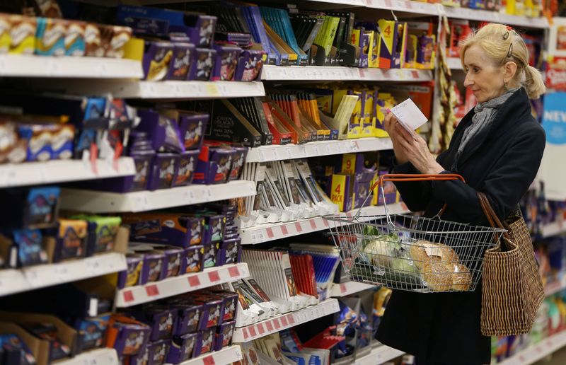 &copy; Reuters. A shopper checks her shopping list in a supermarket in London