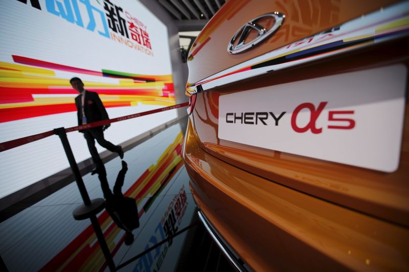 &copy; Reuters. FILE PHOTO:  A visitor walks next to a Chery car during the 16th Shanghai International Automobile Industry Exhibition in Shanghai