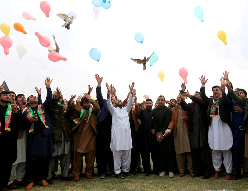 © Reuters. FILE PHOTO: Afghan men celebrate in anticipation of the U.S-Taliban agreement to allow a U.S. troop reduction and a permanent ceasefire, in Jalalabad