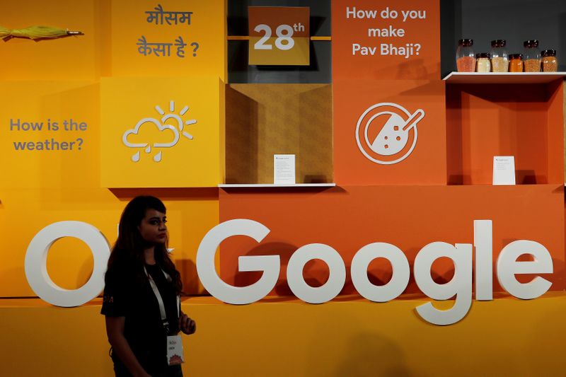 &copy; Reuters. FILE PHOTO: A woman walks past the logo of Google during an event in New Delhi