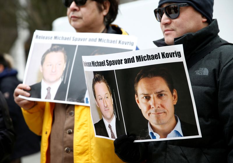&copy; Reuters. FILE PHOTO: People hold signs calling for China to release Canadian detainees Spavor and Kovrig during an extradition hearing for Huawei Technologies Chief Financial Officer Meng Wanzhou at the B.C. Supreme Court in Vancouver