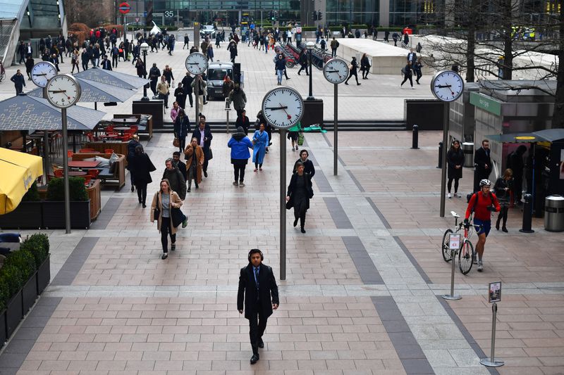 &copy; Reuters. Commuters walk through Canary Wharf in London