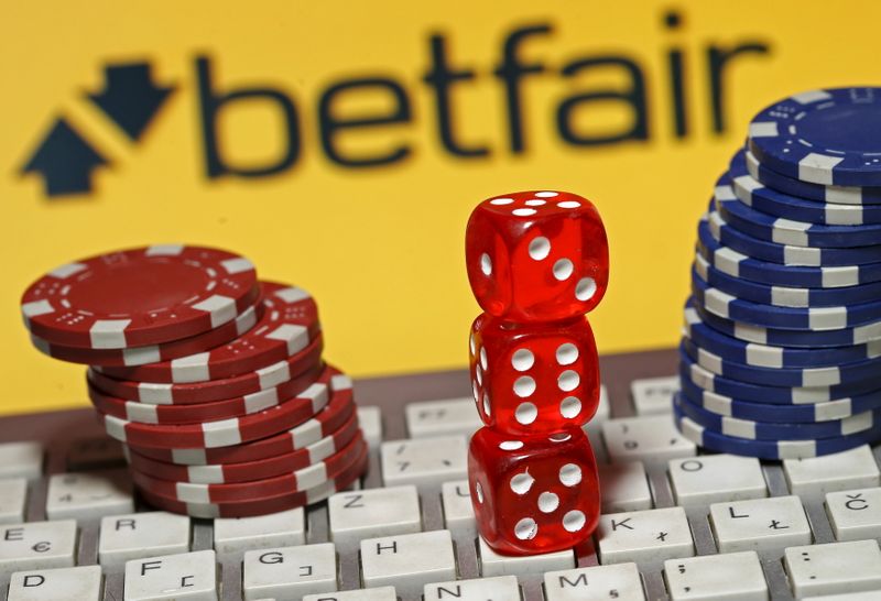 &copy; Reuters. Betfair logo is seen behind a keyboard, gambling dice and chips in this illustration taken in Sarajevo