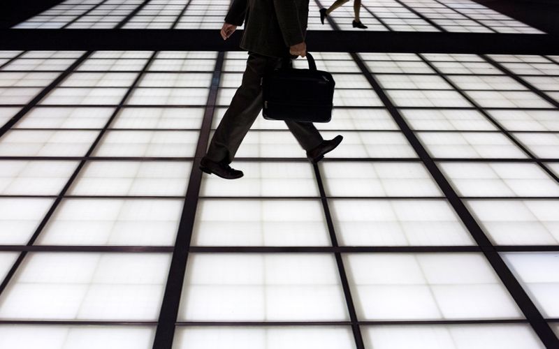 &copy; Reuters. People cross an illuminated floor at a banking district in central Tokyo