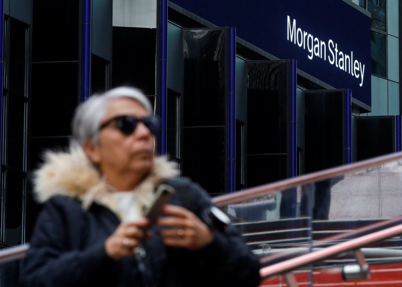 &copy; Reuters. FILE PHOTO:  A woman takes photos by the Morgan Stanley building in Times Square in New York