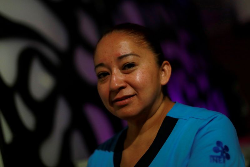 &copy; Reuters. Nurse Gisela Hernandez, who has stayed away from her children for nearly two months to avoid infecting them because she feels inadequately protected, poses for a photograph at her hotel room in Mexico City