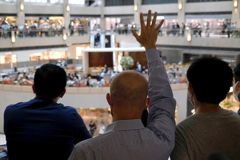 &copy; Reuters. FILE PHOTO: A pro-democracy demonstrator raises his hand up as a symbol of the &quot;Five demands, not one less&quot; during a protest against Beijing&apos;s plans to impose national security legislation in Hong Kong