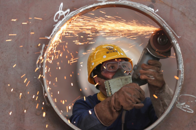 &copy; Reuters. Employee works on a production line manufacturing steel structures at a factory in Huzhou