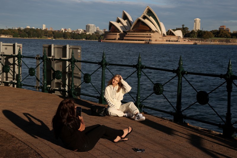 &copy; Reuters. FOTO DE ARCHIVO: Una mujer posa para una foto frente a la Casa de la Ópera en Sídney, Australia, el 20 de mayo de 2020