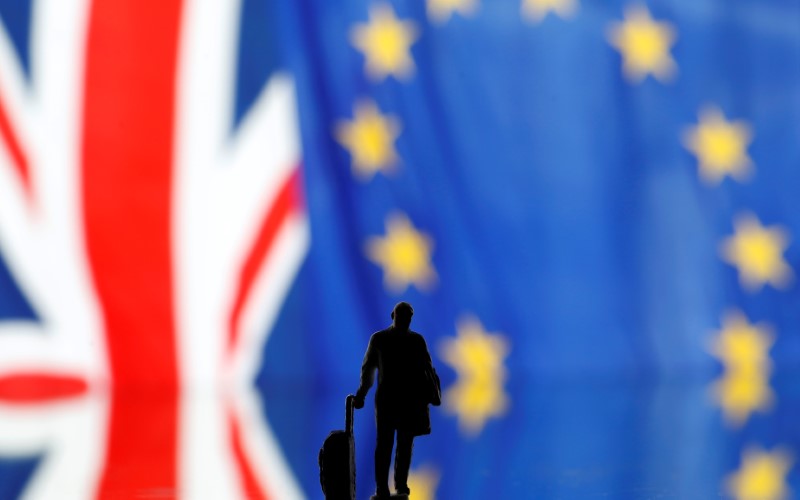 &copy; Reuters. Small toy figure is seen in front of UK and European Union displayed flags in this illustration picture