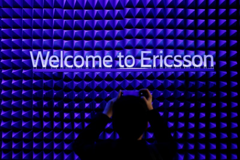 &copy; Reuters. A visitor takes a picture with his mobile phone in front of the Ericsson booth at the Mobile World Congress in Barcelona