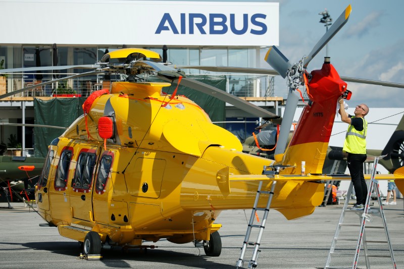 &copy; Reuters. A worker cleans up a H175 Airbus helicopter on the static display, two days before the opening of the 53rd International Paris Air Show at Le Bourget Airport near Paris