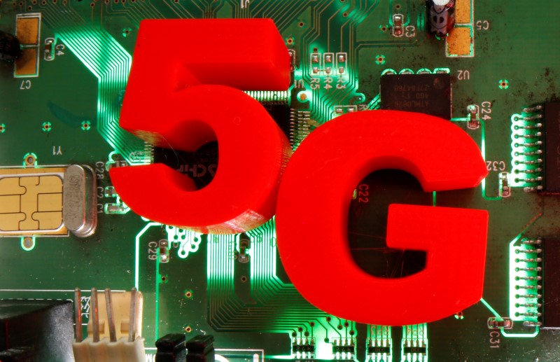 © Reuters. 3d printed objects representing 5G are put on a motherboard in this picture illustration