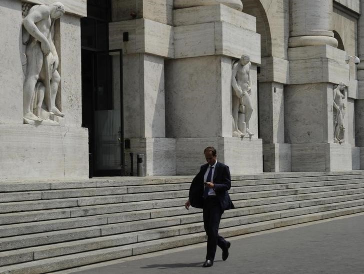 &copy; Reuters. Un uomo passa accanto alla sede della Borsa di Milano