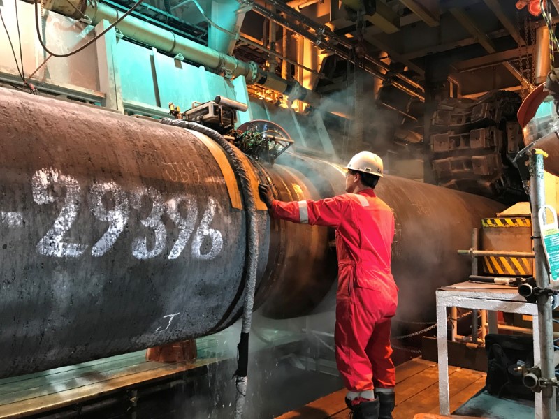 &copy; Reuters. FILE PHOTO: A specialist works onboard the Allseas&apos; deep sea pipe laying ship Solitaire to prepare a pipe for Nord Stream 2 pipeline in the Baltic Sea