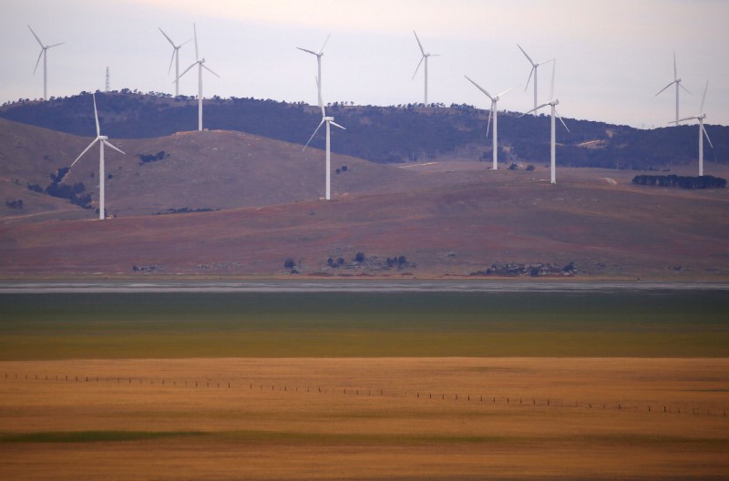 &copy; Reuters. A fence is seen in front of wind turbines that are part of the Infigen Energy Capital Wind Farm located on the hills surrounding Lake George, near the Australian capital city of Canberra
