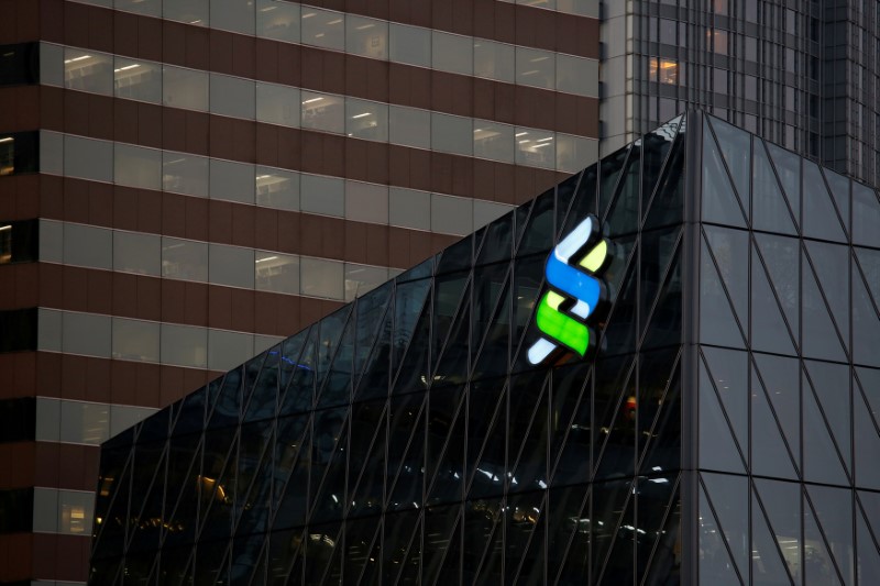 &copy; Reuters. A logo of Standard Chartered is displayed at the financial Central district in Hong Kong