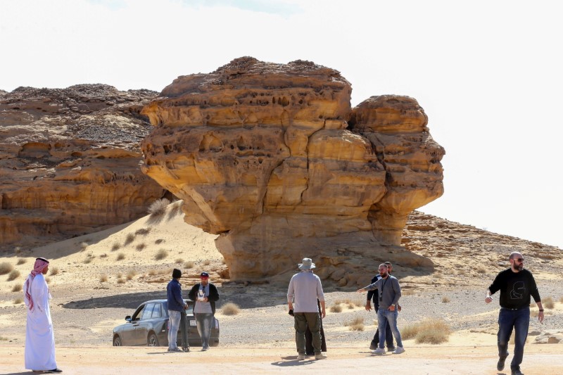 &copy; Reuters. Visitors tour near Rock formations that resemble human face at the Madain Saleh antiquities site in Al-Ula