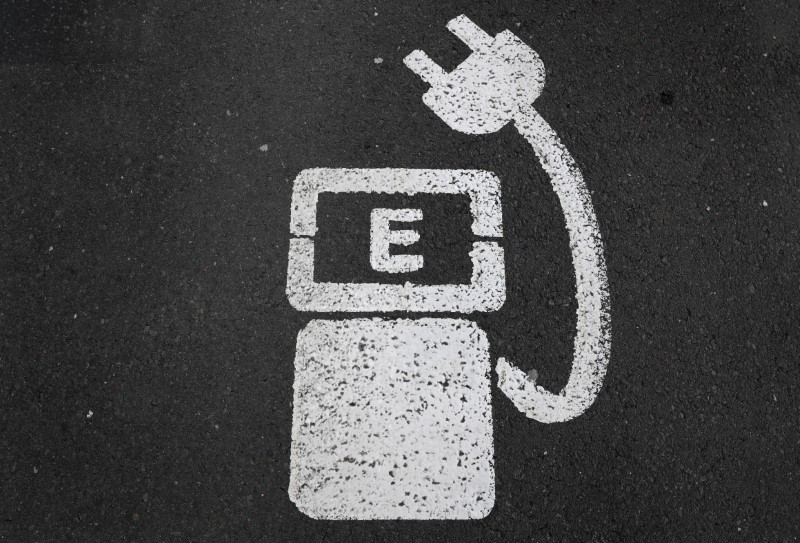 &copy; Reuters. A battery charger sign for electric cars is painted on the ground of a parking ground near the soccer stadium in Wolfsburg