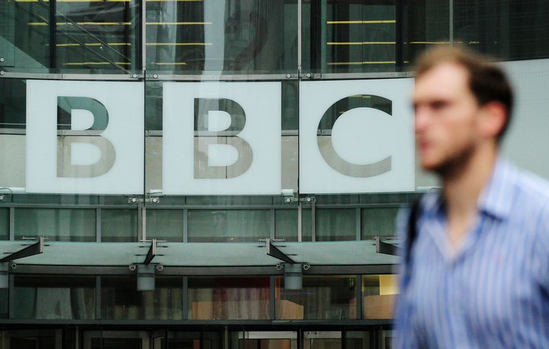 &copy; Reuters. A pedestrian walks past a BBC logo at Broadcasting House in central London