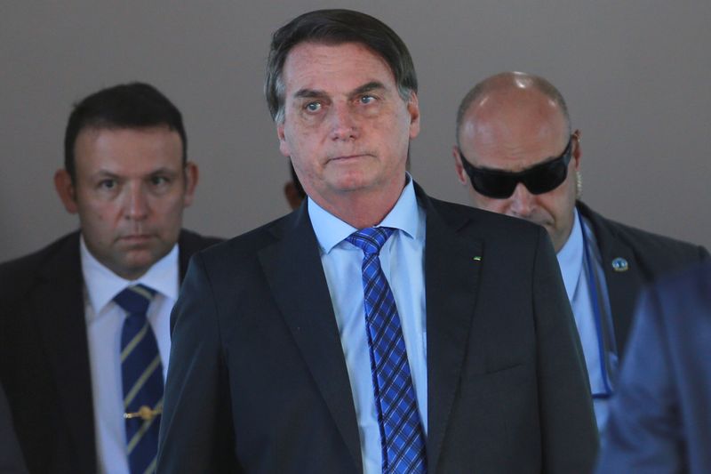 &copy; Reuters. FILE PHOTO: Brazil&apos;s President Jair Bolsonaro walks after a meeting at the Ministry of Defense headquarters, amid the coronavirus disease (COVID-19) outbreak, in Brasilia