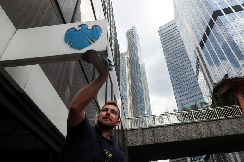 &copy; Reuters. A worker cleans a Barclays logo outside a bank branch in the financial district of London
