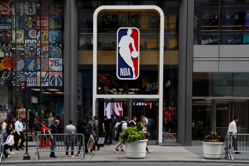 &copy; Reuters. FILE PHOTO: The NBA logo is displayed as people pass by the NBA Store in New York