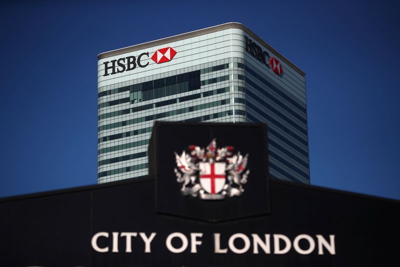 &copy; Reuters. HSBC&apos;s building in Canary Wharf is seen behind a City of London sign outside Billingsgate Market in London