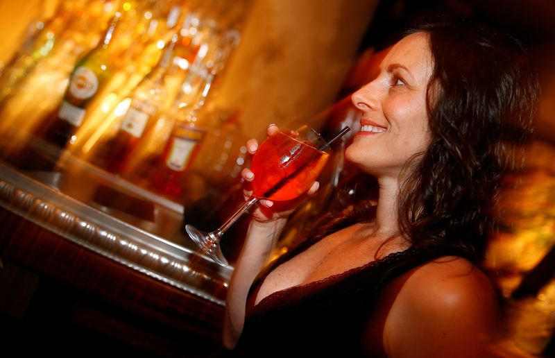 &copy; Reuters. FILE PHOTO: A woman drinks a spritz cocktail with Aperol at the &quot;Spirit de Milan&quot; in Milan