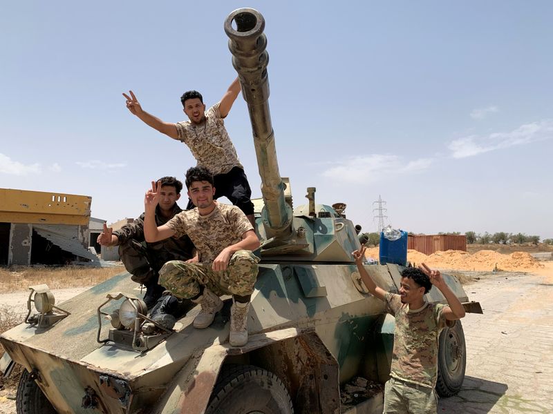 &copy; Reuters. FILE PHOTO: Fighters loyal to Libya&apos;s internationally recognised government celebrate after regaining control over Tripoli