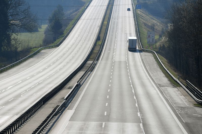 © Reuters. FILE PHOTO: A truck and a car drive on the motorway A8 between Salzburg and Munich near Irschenberg