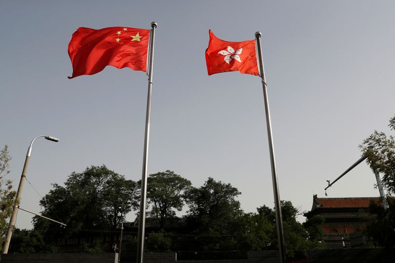 &copy; Reuters. The Chinese and Hong Kong flags flutter at the office of the Government of the Hong Kong Special Administrative Region, ahead of a news conference held by Hong Kong Chief Executive Carrie Lam, in Beijing