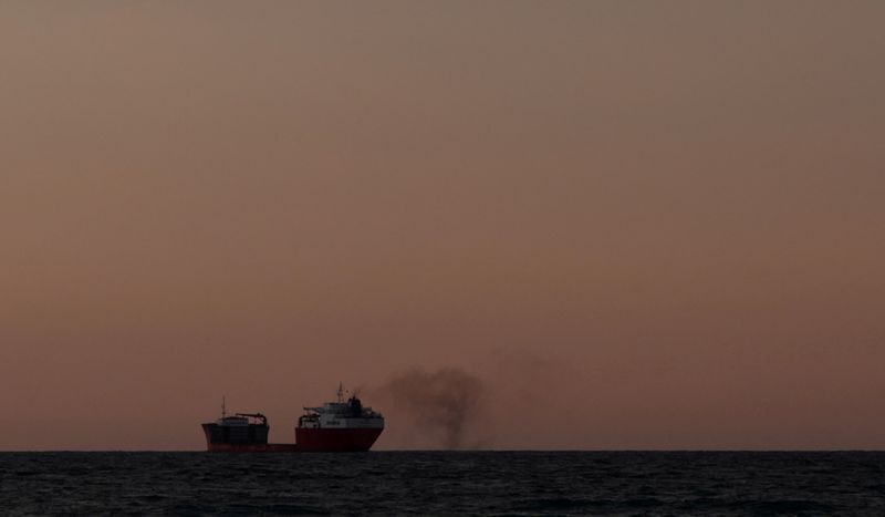 &copy; Reuters. FILE PHOTO: Smoke is blown from a cargo ship off the coast of Falmouth