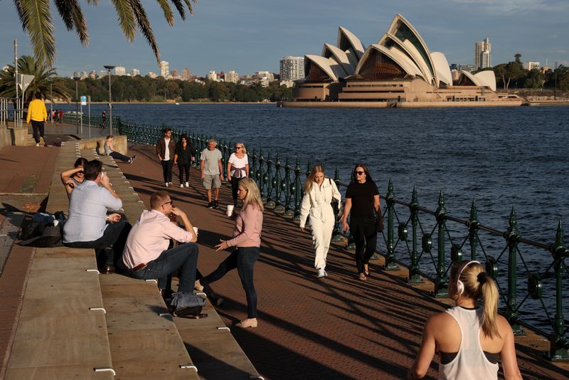 &copy; Reuters. People enjoy a sunny evening by the water in front of the Sydney Opera House in Sydney