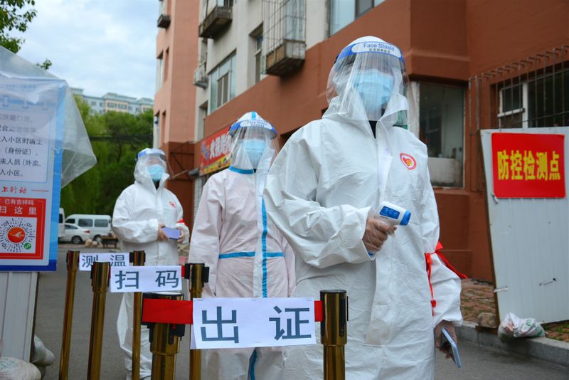 &copy; Reuters. FILE PHOTO:  Volunteers in protective suits are seen a checkpoint following the coronavirus disease (COVID-19) outbreak, in Jilin
