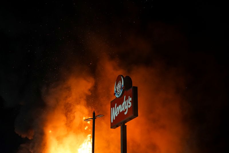 &copy; Reuters. A Wendy’s burns following a rally against racial inequality and the police shooting death of Rayshard Brooks, in Atlanta