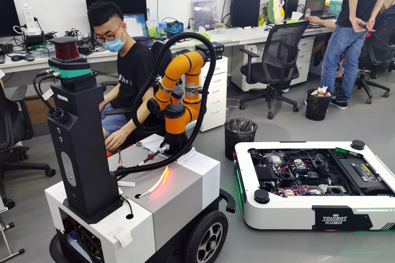 &copy; Reuters. Youibot engineer works on one of its automated guided vehicle designs in the robotics company&apos;s engineering laboratory in Shenzhen