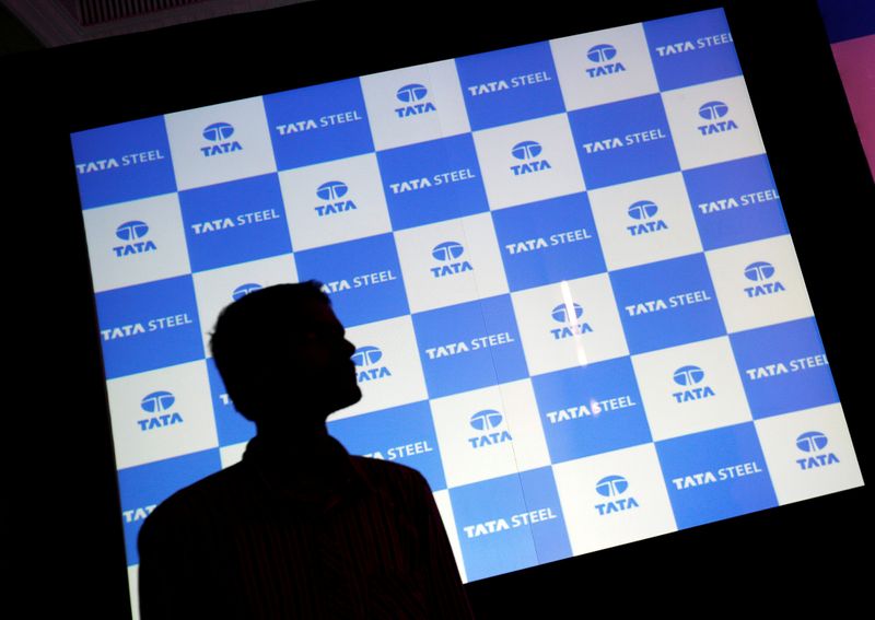 &copy; Reuters. FILE PHOTO: A man walks past a screen displaying Tata Steel logo before the start of a news conference in Mumbai