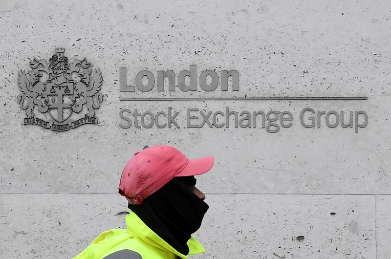 © Reuters. FILE PHOTO: A street cleaning operative walks past the London Stock Exchange Group building in the City of London financial district, whilst British stocks tumble as investors fear that the coronavirus outbreak could stall the global economy, in London